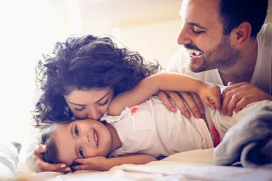 Family of 3 having fun at home.